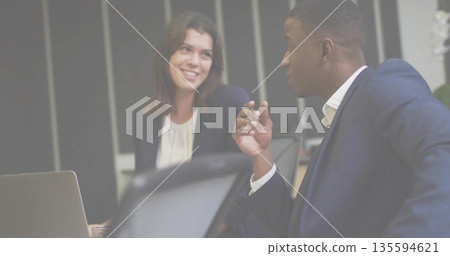 Reviewing report colleagues in business attire sitting at conference table with silver laptop Reviewing report colleagues in business attire sitting at conference table with silver laptop 135594621