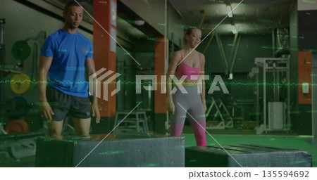 Training partners executing jump drills in gym, with plyometric boxes and performance graphics Training partners executing jump drills in gym, with plyometric boxes and performance graphics 135594692