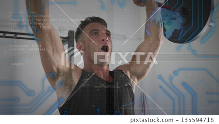 Muscular man in black tank top lifting plate under pull-up bar in gym, with digital overlay 135594718