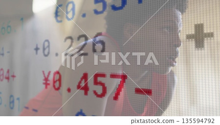 Kneeling woman in red sportswear in studio by colored screen showing euro yen rates, copy space Kneeling woman in red sportswear in studio by colored screen showing euro yen rates, copy space 135594792
