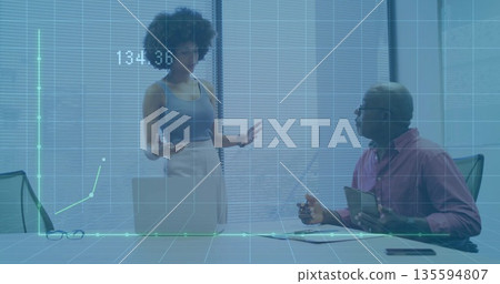 Analyzing finance data at table team wearing work attire with laptop projected chart reading 134 Analyzing finance data at table team wearing work attire with laptop projected chart reading 134 135594807