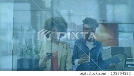 Walking colleagues carrying smartphone, coffee cup, blue folder in office hall, with digital charts Walking colleagues carrying smartphone, coffee cup, blue folder in office hall, with digital charts 135594823