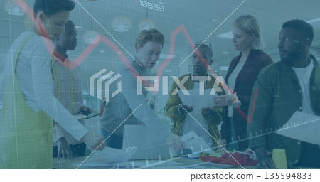 Collaborating team reviewing sketches and fabric samples at design studio with laptop, yellow apron Collaborating team reviewing sketches and fabric samples at design studio with laptop, yellow apron 135594833