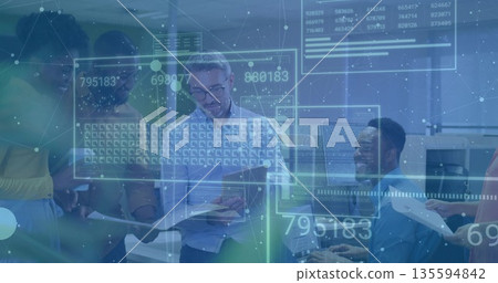 Five office workers analyzing reports at workstations in modern office, with digital data overlays 135594842