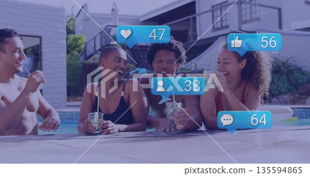Leaning friends wearing swimsuits sipping cocktails poolside, showing floating social media icons Leaning friends wearing swimsuits sipping cocktails poolside, showing floating social media icons 135594865