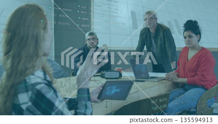 Collaborating professionals planning in meeting room with tablet laptops VR headset coffee mug Collaborating professionals planning in meeting room with tablet laptops VR headset coffee mug 135594913