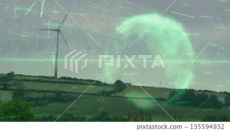 White three-bladed wind turbine standing in rural farmland with digital orb and data overlays 135594932