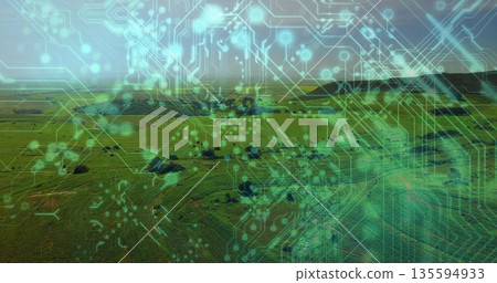 Displaying farm fields with trees in rural farmland, overlaying circuit traces and digital nodes 135594933
