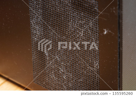 Dusty fan grille of an office computer close up 135595260