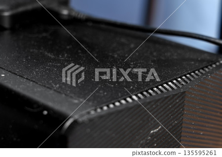 Dusty office computer with external memory drive on top close up 135595261