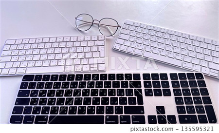 Efficient Remote Work Station Featuring Two Keyboards And Glasses, Creative And Organized Workspace Showing Two Keyboard Setups Optimized For Multitasking Remote Tasks Efficient Remote Work Station Featuring Two Keyboards And Glasses, Creative And Organized Workspace Showing Two Keyboard Setups Optimized For Multitasking Remote Tasks 135595321