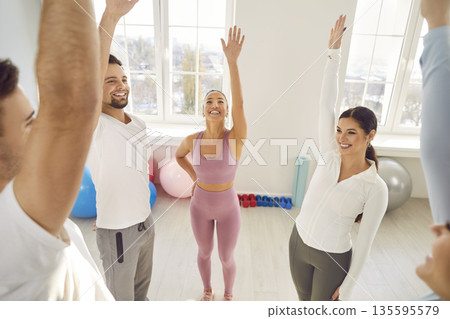 Happy Sports Team Performing Stretching Exercise Together 135595579