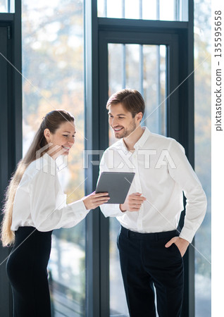 Young managers checking something online and looking excited 135595658