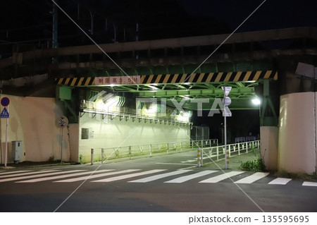 Night view of an elevated railway tunnel with a height limit sign: Color Night view of an elevated railway tunnel with a height limit sign: Color 135595695