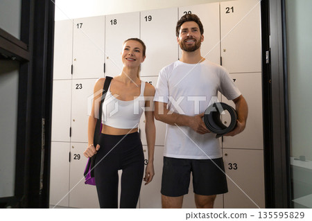 Two people in a gym before workout feeling excited Two people in a gym before workout feeling excited 135595829