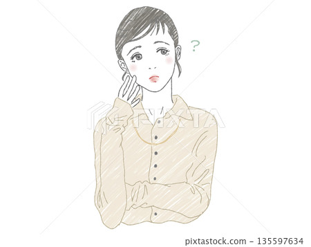 A woman tilting her head with her hand on her face A woman tilting her head with her hand on her face 135597634