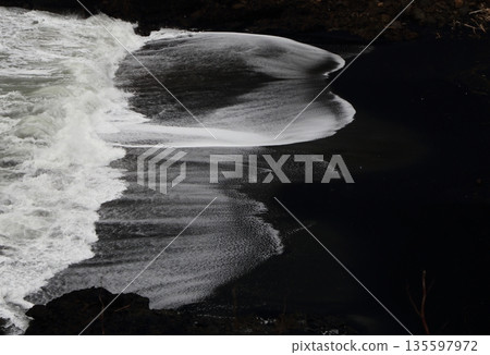 Beautiful waves on a black sand beach 135597972