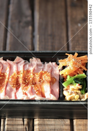 Roast beef bento in a disposable takeout container 135598442