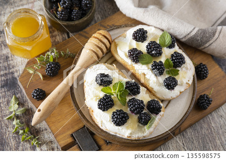 Rustic blackberry and ricotta toast with honey for breakfast inspiration Rustic blackberry and ricotta toast with honey for breakfast inspiration 135598575