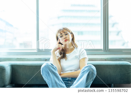 Woman thinking by the window 135598702