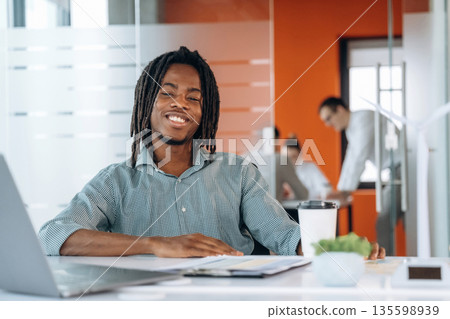 Cup of fresh coffee. People are working in the office together 135598939