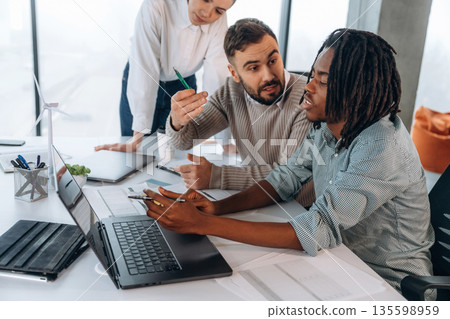 Talking, communication between colleagues. People are working in the office together Talking, communication between colleagues. People are working in the office together 135598959