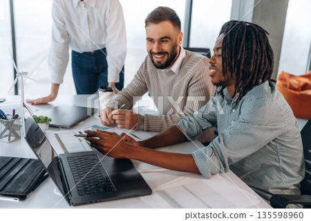 Talking, communication between colleagues. People are working in the office together Talking, communication between colleagues. People are working in the office together 135598960