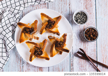 Shaped toasts with strawberry jam on a plate on the table top view 135599014
