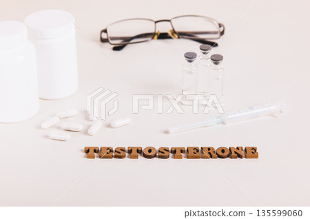 Syringe, ampoules and capsules for regulating testosterone levels on a light background Syringe, ampoules and capsules for regulating testosterone levels on a light background 135599060