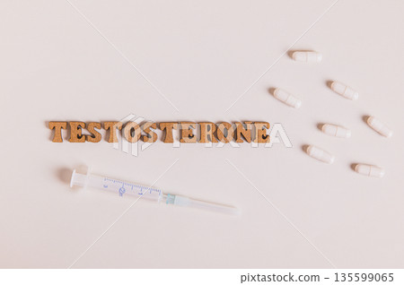 Close up of syringe and capsules for regulating testosterone levels top view Close up of syringe and capsules for regulating testosterone levels top view 135599065