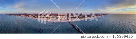 Aerial winter panorama of Groemitz coastline and pier 135599430