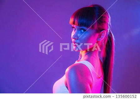 Blue and red neon lighting. Young sportive woman is in the studio Blue and red neon lighting. Young sportive woman is in the studio 135600152