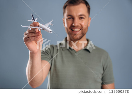 Airline concept, travel, ready for vacation. Handsome man is against background 135600278