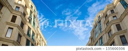 Classic European style apartment building facade with curved architecture Classic European style apartment building facade with curved architecture 135600306