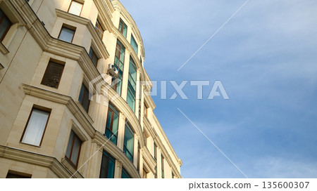 Classic European style apartment building facade with curved architecture Classic European style apartment building facade with curved architecture 135600307