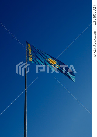 Flag of Kazakhstan against blue sky Flag of Kazakhstan against blue sky 135600327