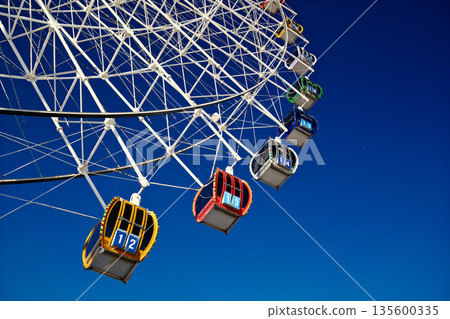 Colorful Ferris wheel cabins close up, amusement park ride details 135600335