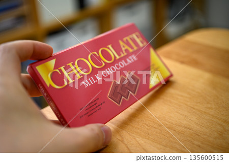 Milk chocolate in hand 135600515