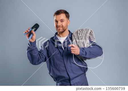 Worker is ready to install the internet connection. Handsome man is against background 135600739