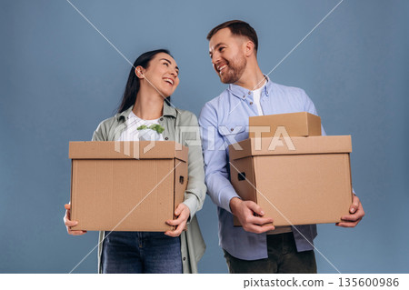 Couple is ready to move, with boxes. Man and woman are in the studio 135600986