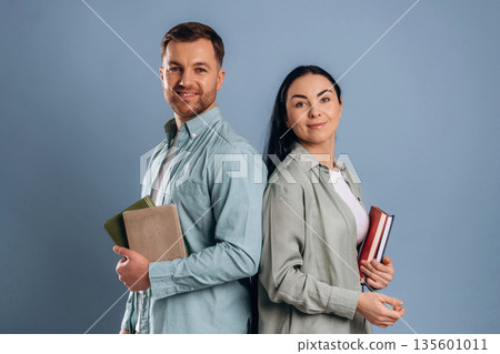 Education concept, ready for university. Man and woman are in the studio Education concept, ready for university. Man and woman are in the studio 135601011