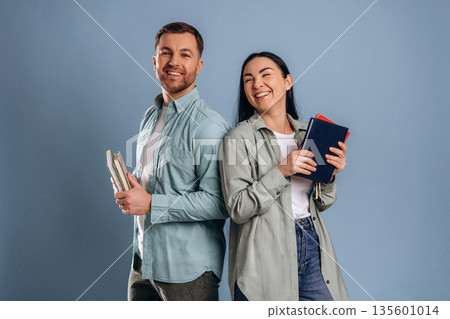 Education concept, ready for university. Man and woman are in the studio Education concept, ready for university. Man and woman are in the studio 135601014