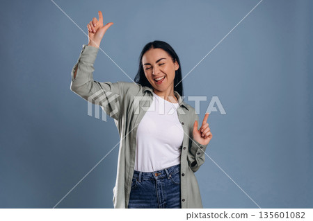 Pointing the fingers, fun. Beautiful woman is against background Pointing the fingers, fun. Beautiful woman is against background 135601082