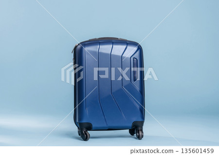 Suitcase against light blue background 135601459