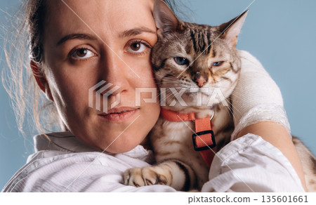 Female veterinarian is with Bengal cat 135601661