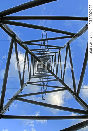 Power transmission tower against blue sky perspective view 135602095