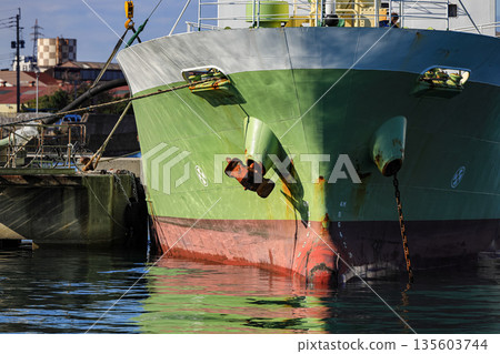 The bow of the ship with the anchor installed. The rust anchor of the ship. The bow of the ship with the anchor installed. The rust anchor of the ship. 135603744