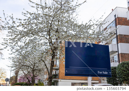 Real Estate For Sale Sign in Front of Residential Building 135603794