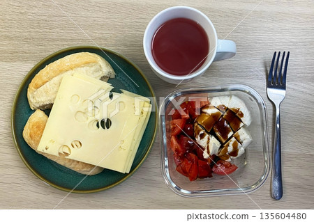 Continental Breakfast with Emmental Cheese, Bread Rolls, and Caprese Salad Continental Breakfast with Emmental Cheese, Bread Rolls, and Caprese Salad 135604480