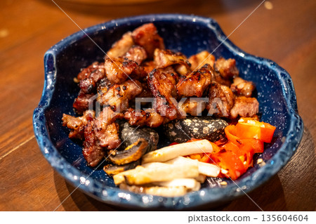 Grilled sliced marinated pork collar, served on the plate Grilled sliced marinated pork collar, served on the plate 135604604